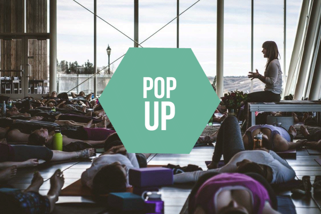 Pop Up Yoga session at the Galt Museum with many participants lying on the floor.
