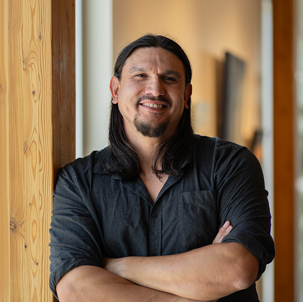 Will Big Bull stands in front of wooden columns at Casa.