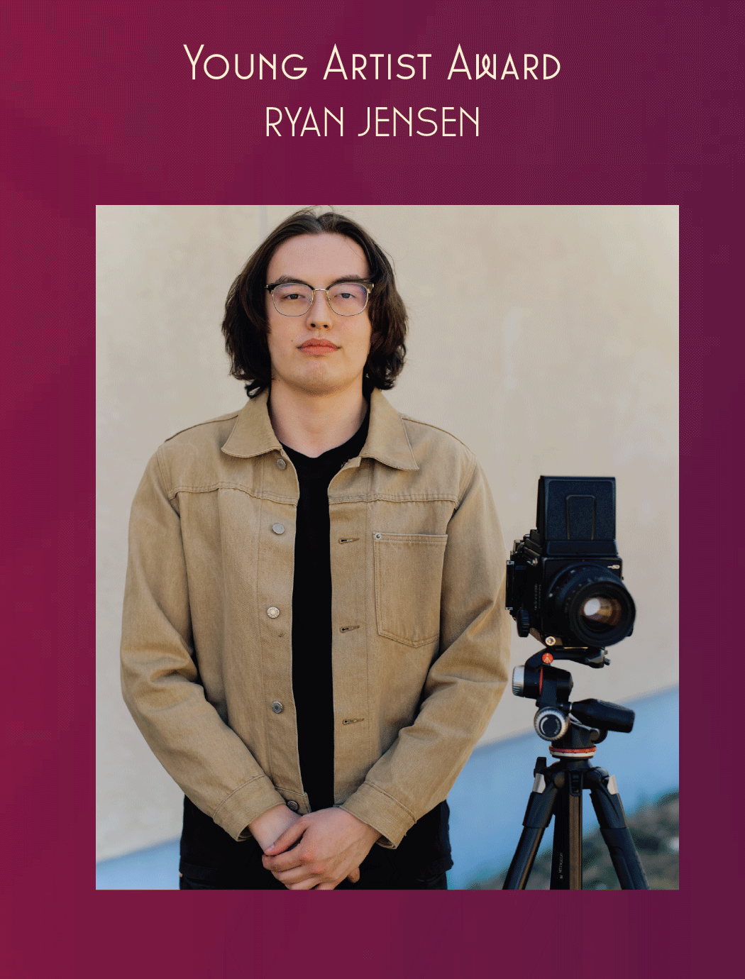 A picture of Ryan Jensen with a camera on a burgundy background as the recipient of the Young Artist Award